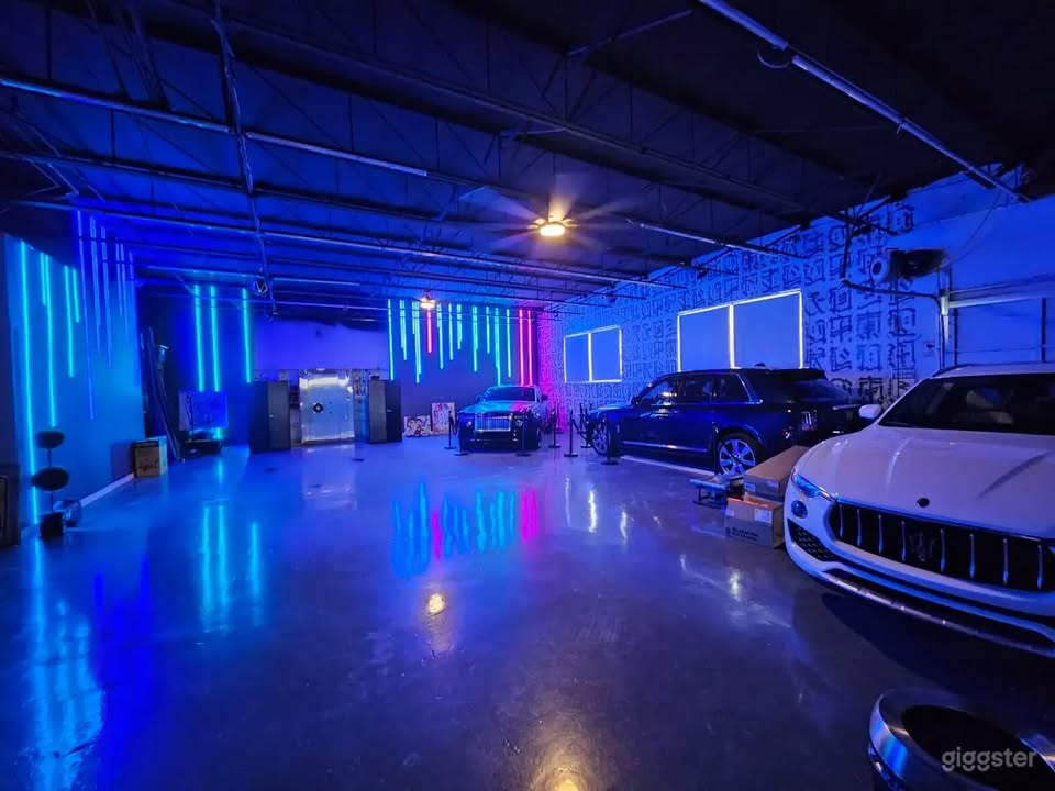 Neon-lit showroom floor with luxury vehicles